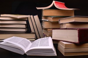 11549095-open-book-and-pile-of-books-against-a-dark-background